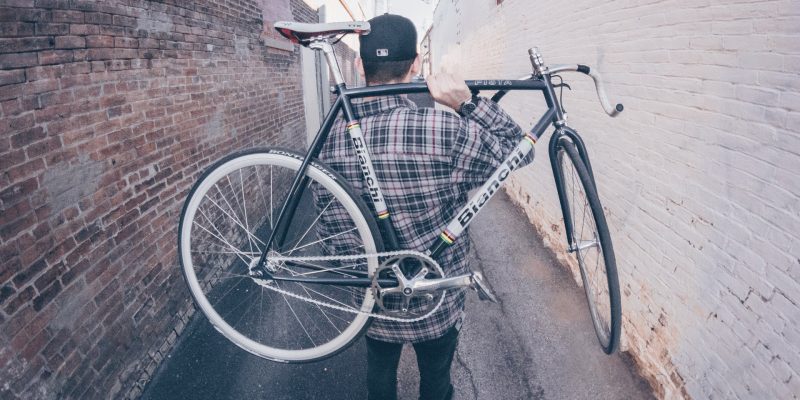 man-carrying-white-and-black-bianchi-road-bike-990427.jpg